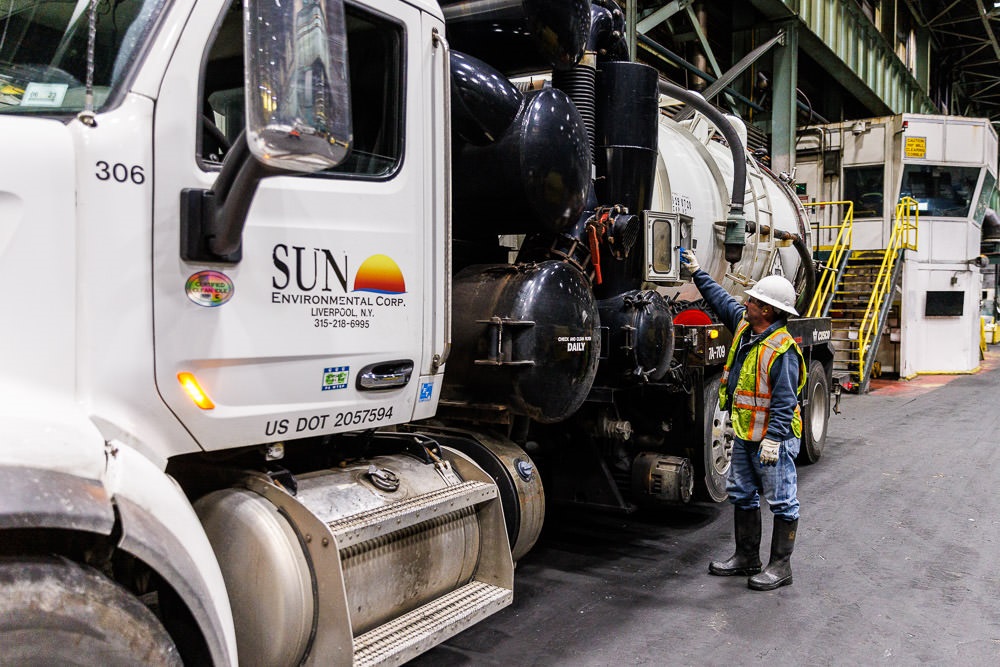 Operator standing next to vacuum truck
